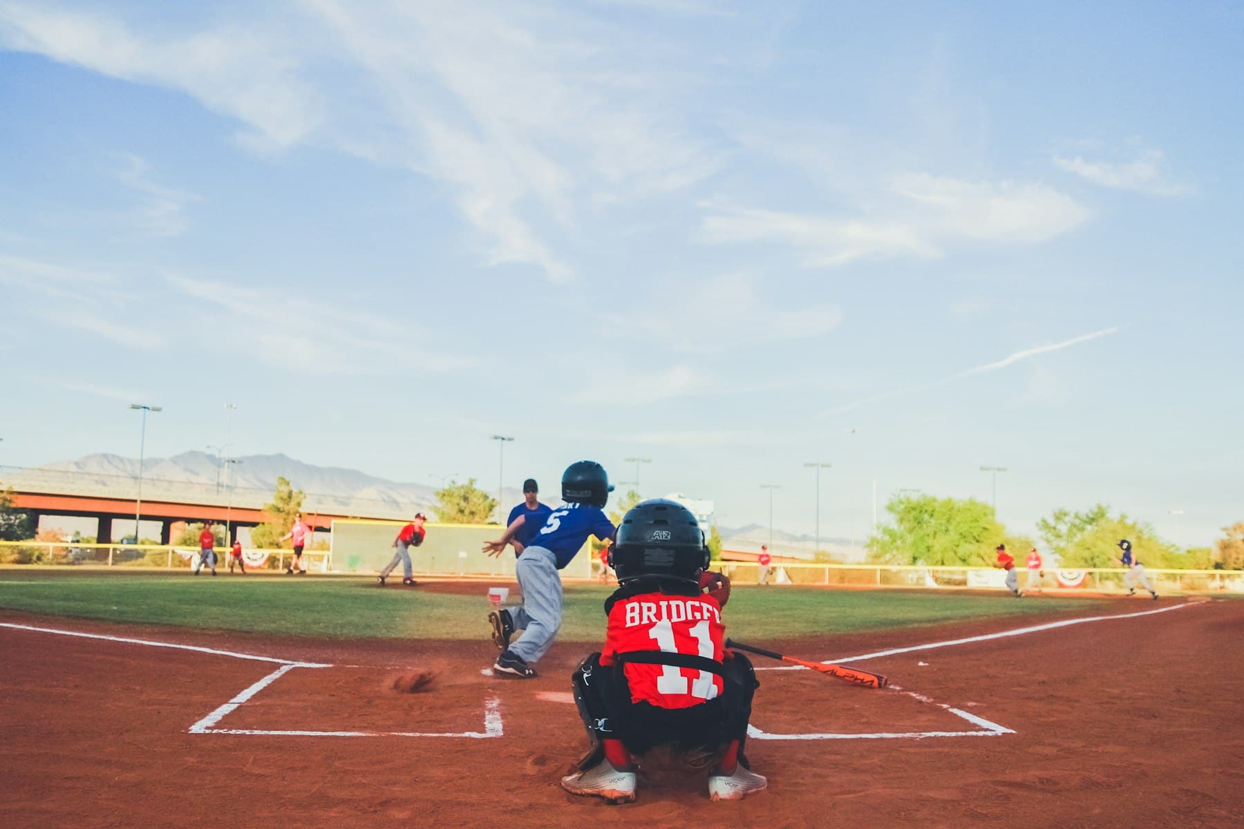 A youth baseball game at dusk
